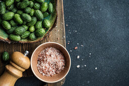 Cucamelon (Mexican mini cucumber, Melothria scabra), pink salt and pepper mill