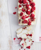 White rocky road cake with freeze-dried raspberries