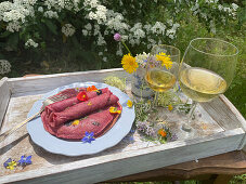 Beetroot crepes with edible flowers