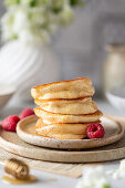 Fluffy Japanese pancakes with honey and raspberries