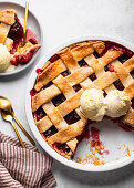 Plum pie with lattice crust served with vanilla ice cream