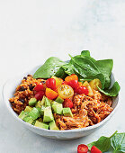 Mexican rice bowl with pulled pork and avocado