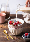 Breakfast muesli with fresh berries and milk