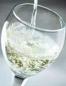 Pouring white wine into a glass