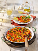 Spanish bean paella with peppers, peas and saffron