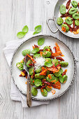 Basil gnocchi with bacon and sun-dried tomatoes