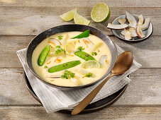 Asparagus soup with pea pods, saffron and coconut chips