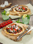 Ground meat pizza with feta and tomatoes