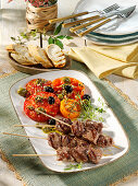 Grilled steak skewers with tomato salad