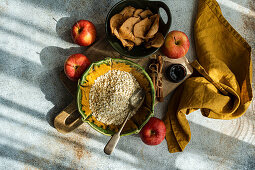 Oat flakes, apples and cinnamon sticks for a healthy breakfast