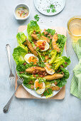 Crispy avocado salad with olive oil and bacon dressing