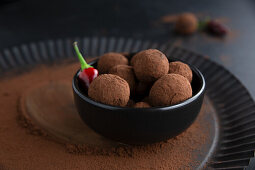 Chocolate pralines coated in cocoa powder with a fine chili flavor