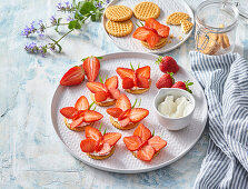 Strawberry butterflies on biscuits