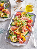 Grilled zucchini salad with prosciutto and peaches