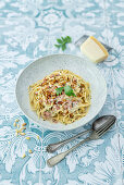Carbonara with miso paste, bacon and marinated pine nuts