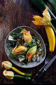 Salad with stuffed zucchini flowers, goat's cheese and olives