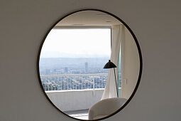 City view reflection in round wall mirror