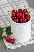 Red cherry in a white ceramic jar