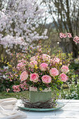 Bouquet of forsythia branches and roses, and birch branches as table decoration