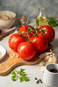 Vine tomatoes and ingredients for tomato sauce