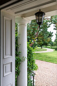 Entrance area of a house with a lantern and a view of the garden