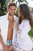 Young couple in love in white outerwear