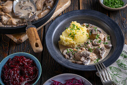 Chicken in mushroom sauce with mashed potatoes and red cabbage