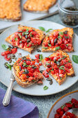Toasted bread with feta and red pesto spread and tomato salad