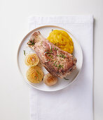 Pork knuckle with sweet potato puree and caramelised onions