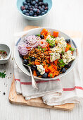 Lentil and sweet potato bowl with blue cheese and blueberries