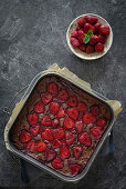 Brownies with strawberries in a flat baking tin