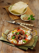 Glazed steak cubes on Chinese cabbage and rice ribbon noodles