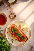 Grilled bruschetta with tomatoes, parsley and cheese