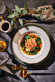 Salmon sashimi in miso broth with courgette, edamame and ginger