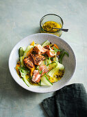 Pulled pepper salmon salad with cucumber, mango and passion fruit dressing