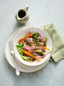 Boiled beef salad with root vegetables, apple and pumpkin seed oil dressing
