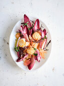 Chicory salad with pomelo, scallops and wild herbs