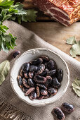 Beetle beans in a bowl and smoked pork neck in the background