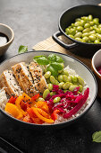 Chicken and pepper poke bowl with edamame and pickled red cabbage