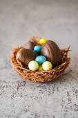 Easter nest of vermicelli and melted chocolate filled with Easter eggs