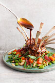 Oven-cooked rack of lamb with ginger marsala jus and sweet potato and bean vegetables