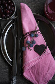 Sloe berries as napkin holder and heart made from sloe fruit leather