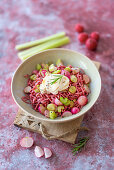 Pink spaghetti with dragon fruit powder, radishes, celery and gratinated goat's cheese