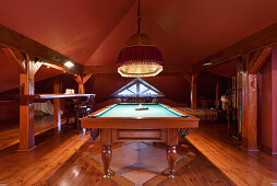 Billiard table with oriental pendant light in attic games room