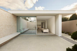 View of minimalist living area and sliding glass door