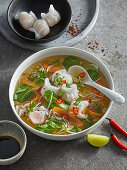 Asian soup with prawn dumplings and pak choi