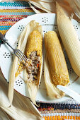 Tamales - corn dough with minced meat filling in corn leaves