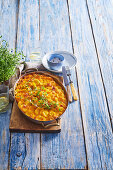 Potato casserole with pumpkin and cheddar sauce and thyme