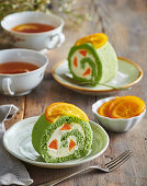 Matcha roulade with candied oranges and cream filling