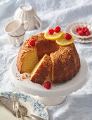 Lemon bundt cake with almond crust and fresh raspberries